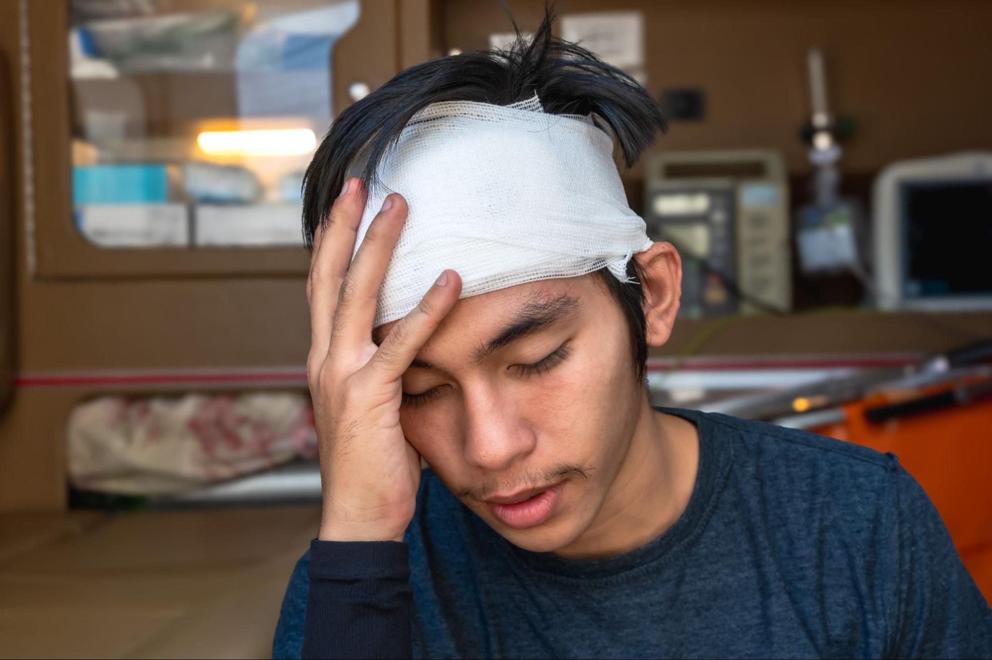 Young man in severe pain in the head